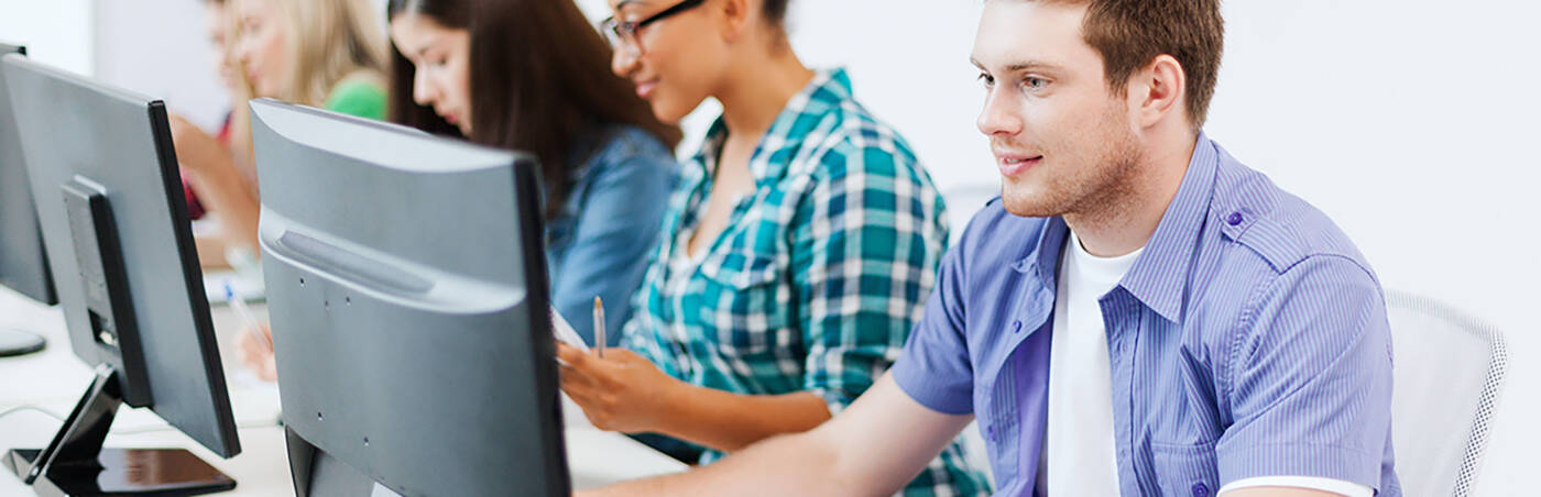 Students using computers in a classroom.