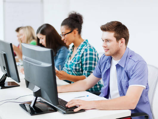 Students using computers in a classroom.