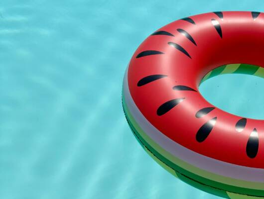 A colorful lifesaver floating on water.